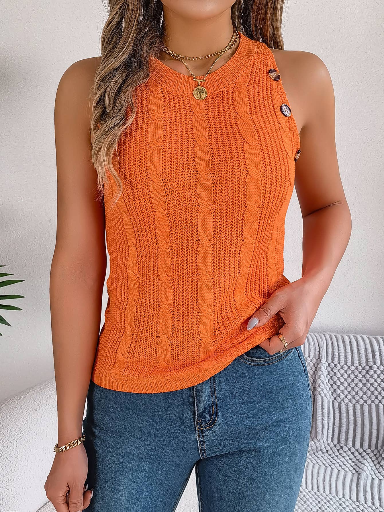 Solid color twist button sleeveless blouse